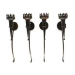 A set of four wrought iron wall sconces of ecclesiastical inspiration,