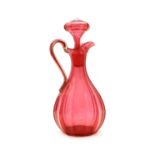A Victorian cranberry glass jug with stopper