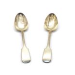 A pair of Victorian silver fiddle pattern basting spoons