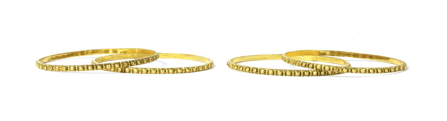 A set of four Indian high carat gold bangles,