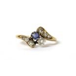 An Edwardian gold sapphire and diamond crossover ring,