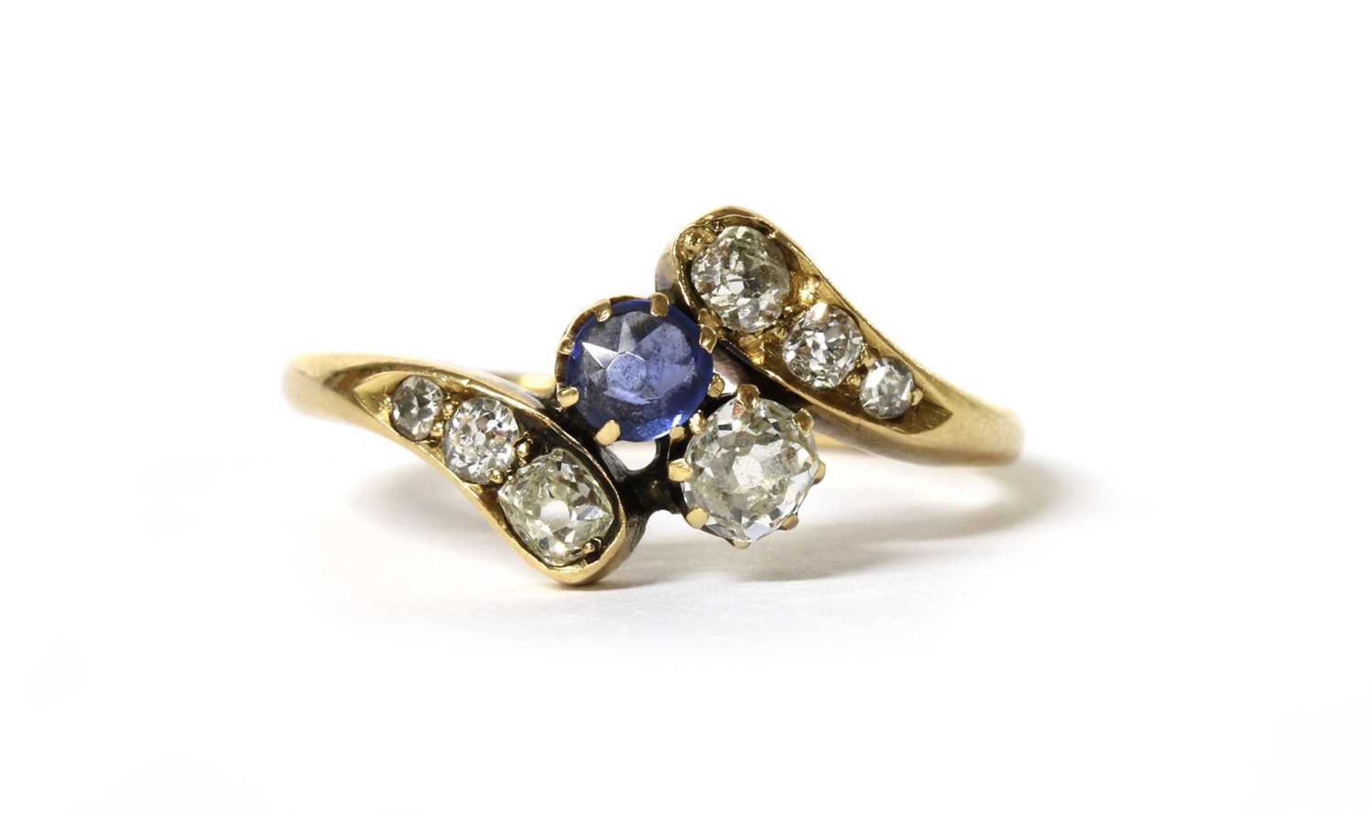 An Edwardian gold sapphire and diamond crossover ring,