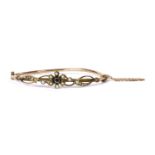 An Edwardian gold sapphire and split pearl bangle,