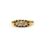 An Edwardian gold three stone diamond ring,