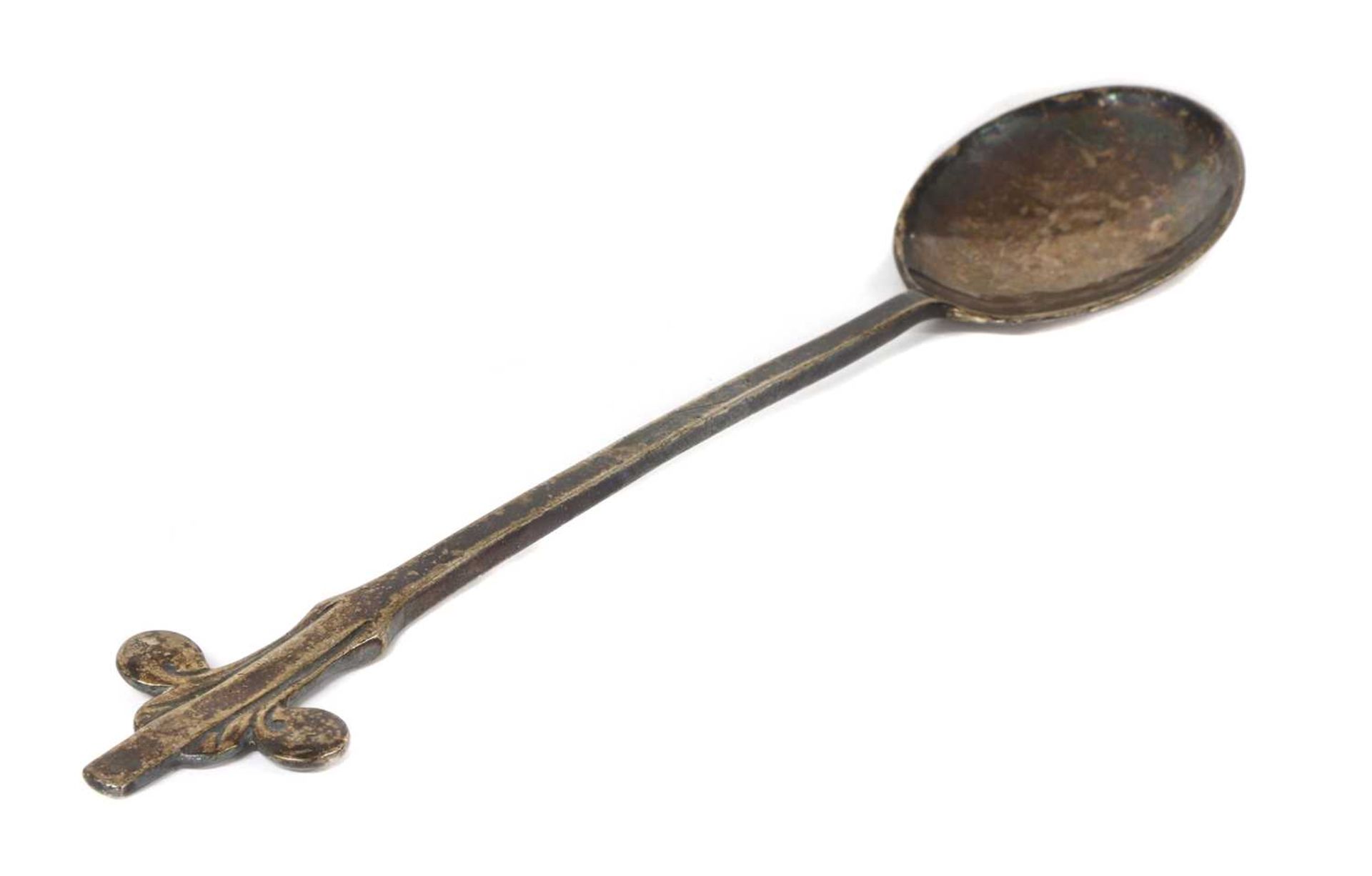 A Liberty & Co. Cymric silver jam spoon, designed by Archibald Knox,