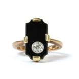 A gold diamond and onyx ring,