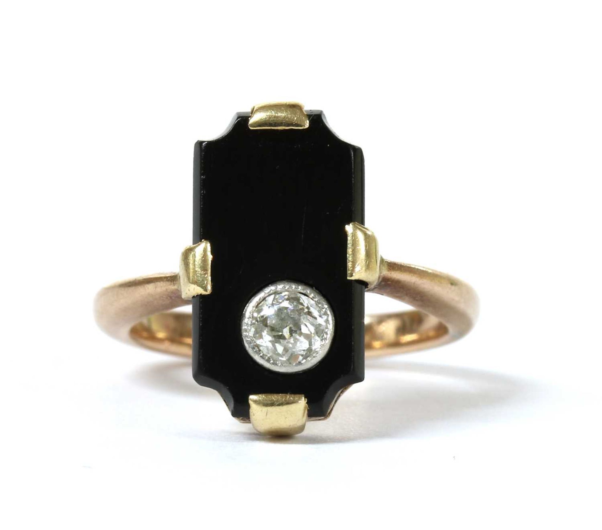 A gold diamond and onyx ring,