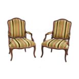 A pair of French Louis XV beech fauteuils,