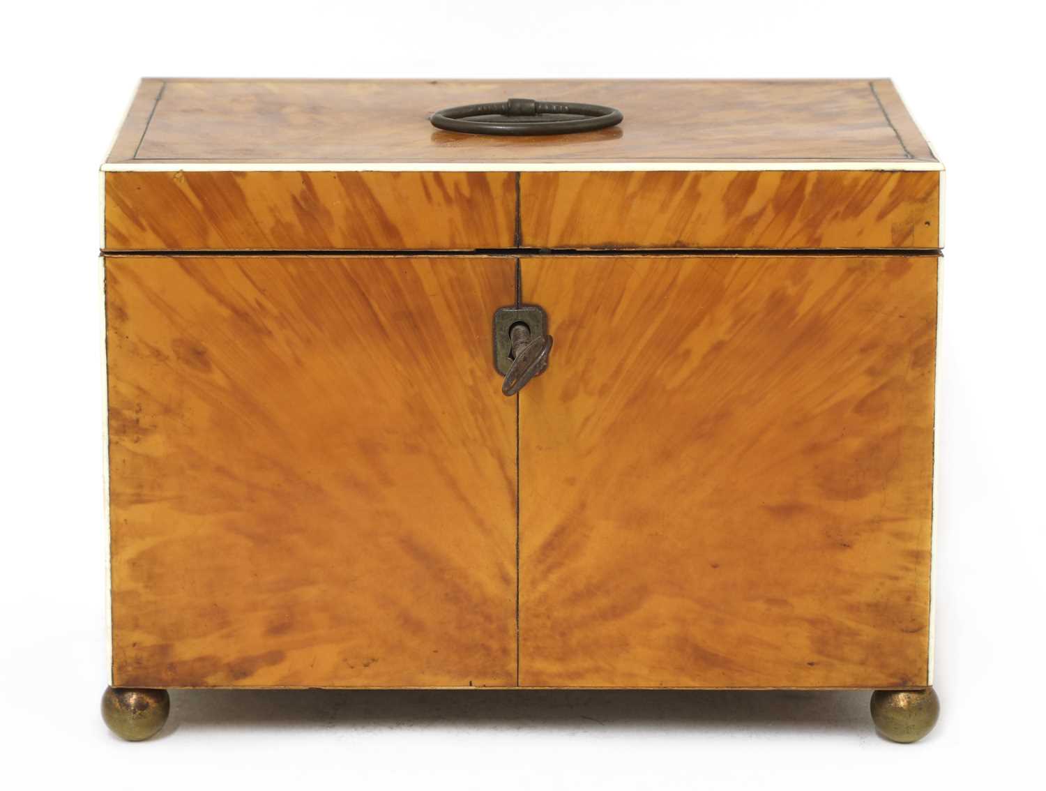 A blond tortoiseshell twin compartment tea caddy,