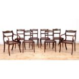 A set of eight simulated rosewood dining chairs,
