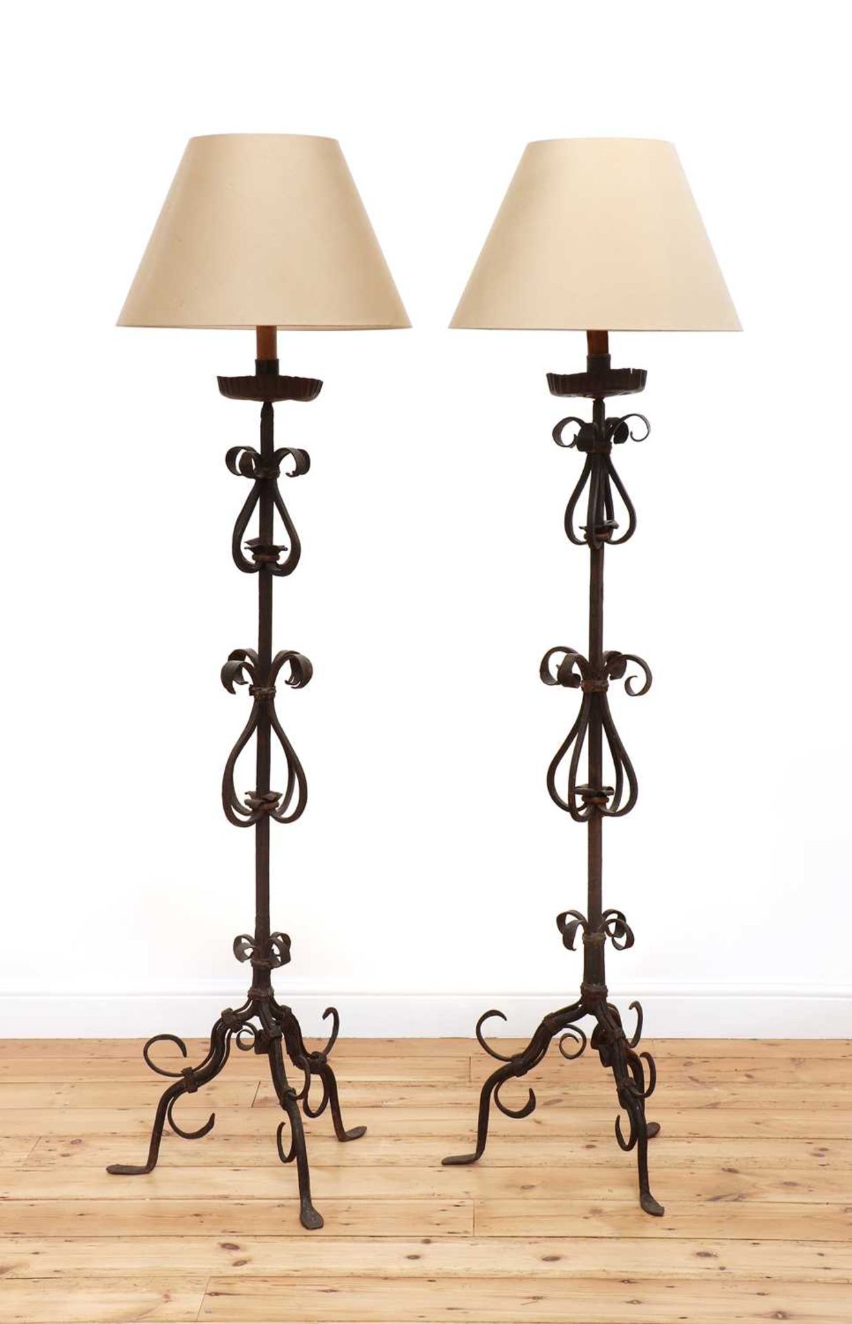 A pair of wrought iron standard lamps,