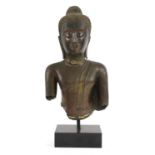 A gilt-bronze bust of Buddha,