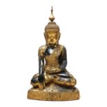 A large South-East Asian wooden and lacquered Shakyamuni buddha,