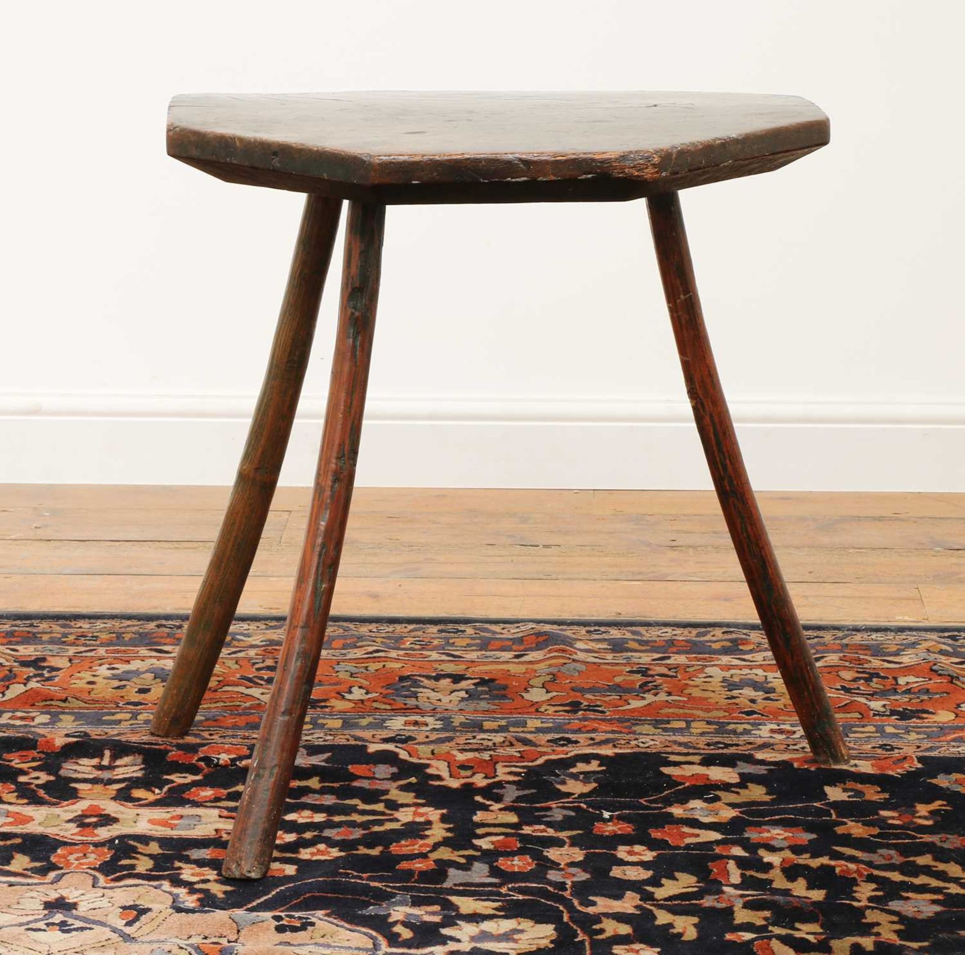 A primitive elm and ash 'cheese top' cricket table,