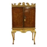 A reproduction cabinet on giltwood stand