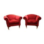 A pair of large red upholstered armchairs by 'Recline and Sprawl',