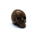 A Japanese lacquered metal skull,