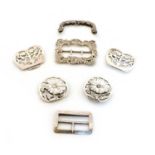 A collection of four silver belt buckles,