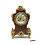 A French red boulle and ebonised mantel clock,