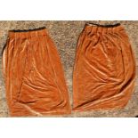 A pair of orange velvet curtains,