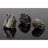 A collection of three naturalistic silver rings,