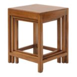 A Cotswold School walnut nest of three tables,