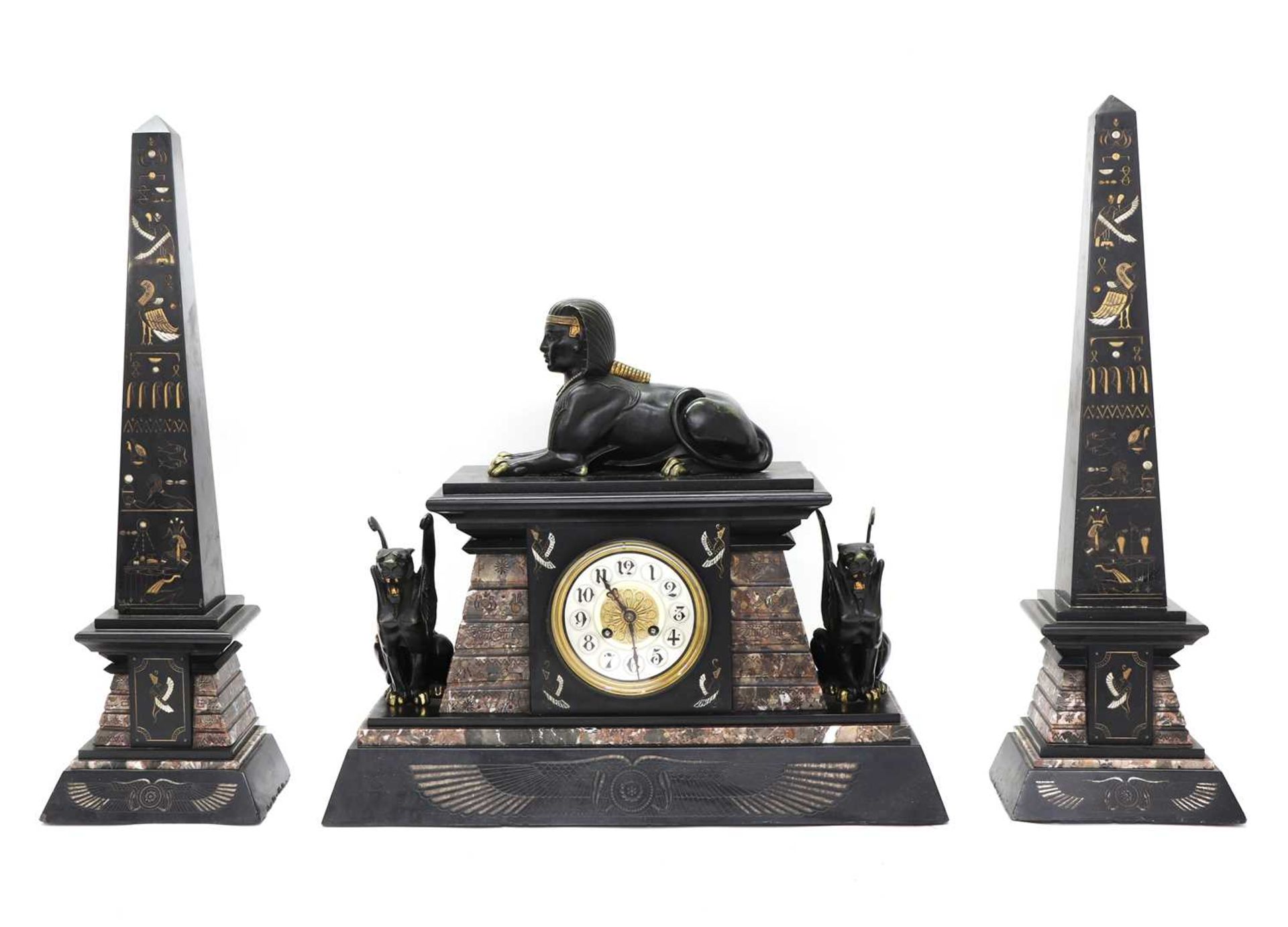 An Egyptian Revival marble and slate mantel clock garniture,