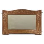 A Scottish Arts and Crafts embossed copper wall mirror,