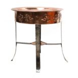 An Arts and Crafts copper-embossed tray-top table,