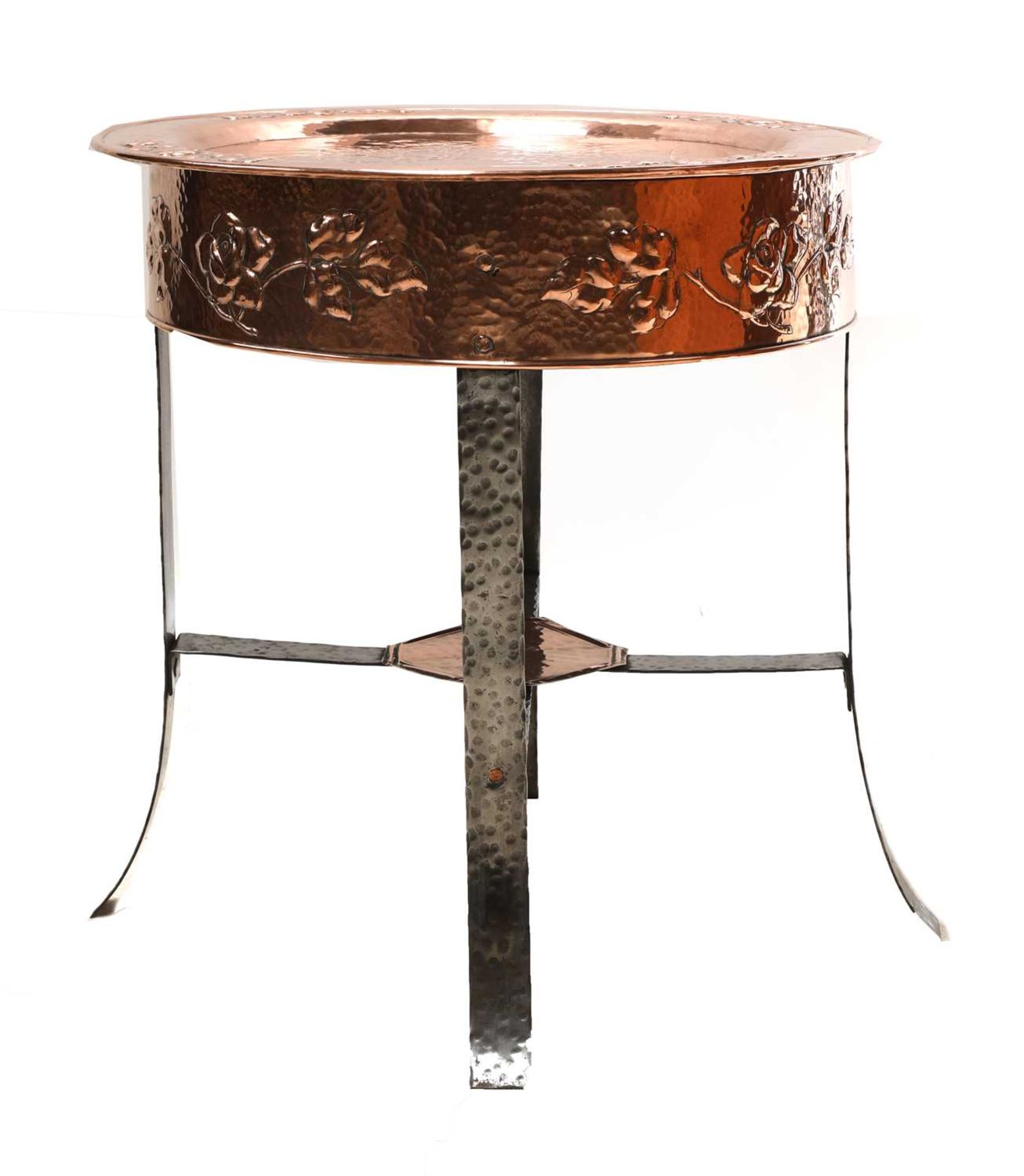 An Arts and Crafts copper-embossed tray-top table,