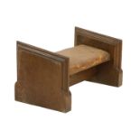 An ecclesiastical oak and leather kneeler,