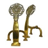 A pair of Arts and Crafts pierced brass firedogs,