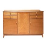 A Cotswold School oak bow-front sideboard,