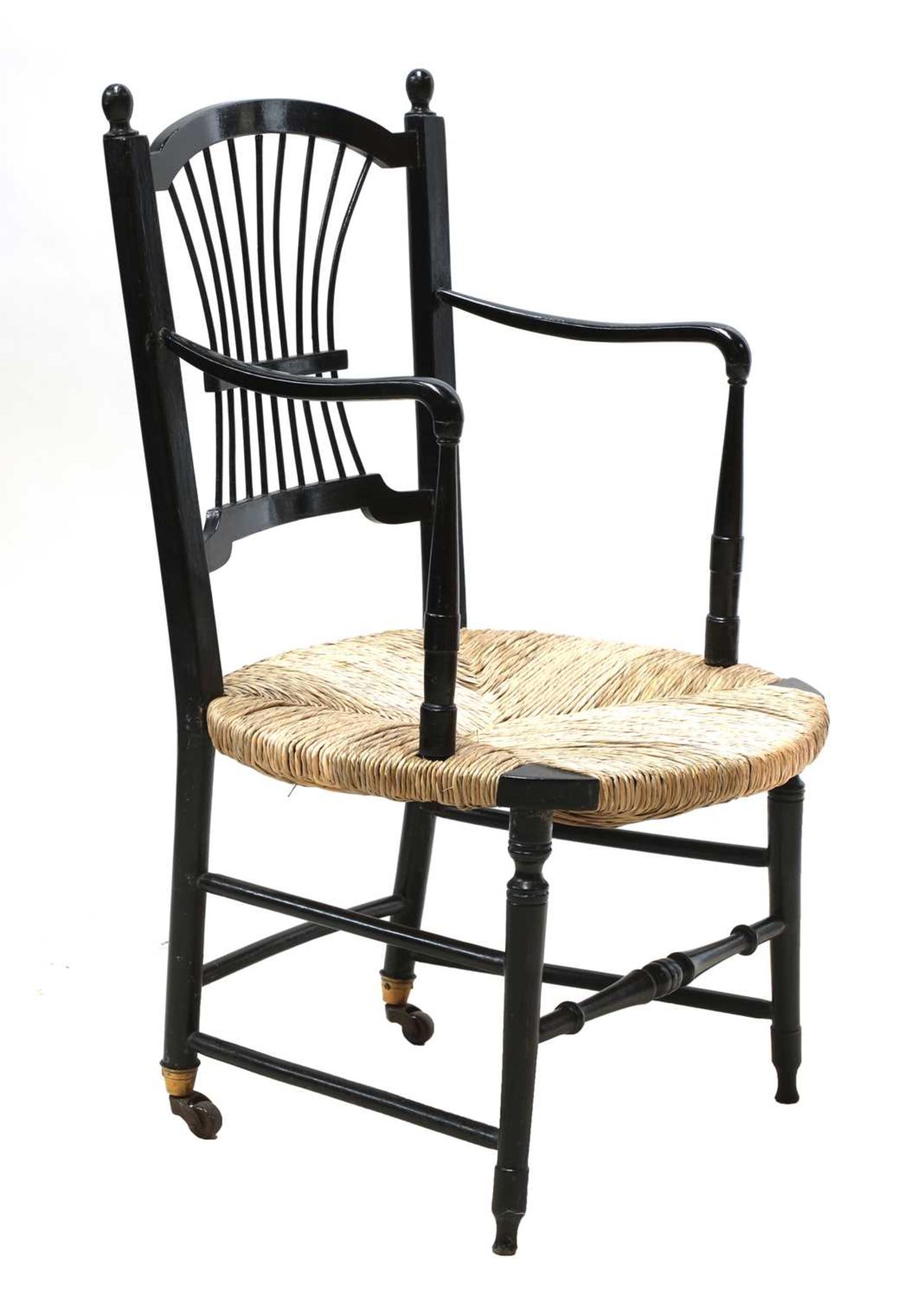 An ebonised 'Sussex' armchair,