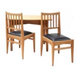 An oak dining table and two chairs,