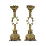 A pair of Gothic Revival brass candlesticks,