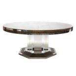 A massive circular glass-panelled dining table,