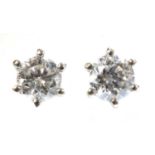 A pair of white gold single stone diamond stud earrings,