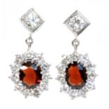 A pair of 18ct white gold garnet and diamond cluster drop earrings,