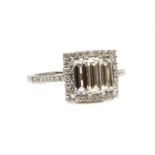 A white gold three stone diamond halo cluster ring,