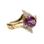 A gold single stone pink sapphire and diamond crossover ring,