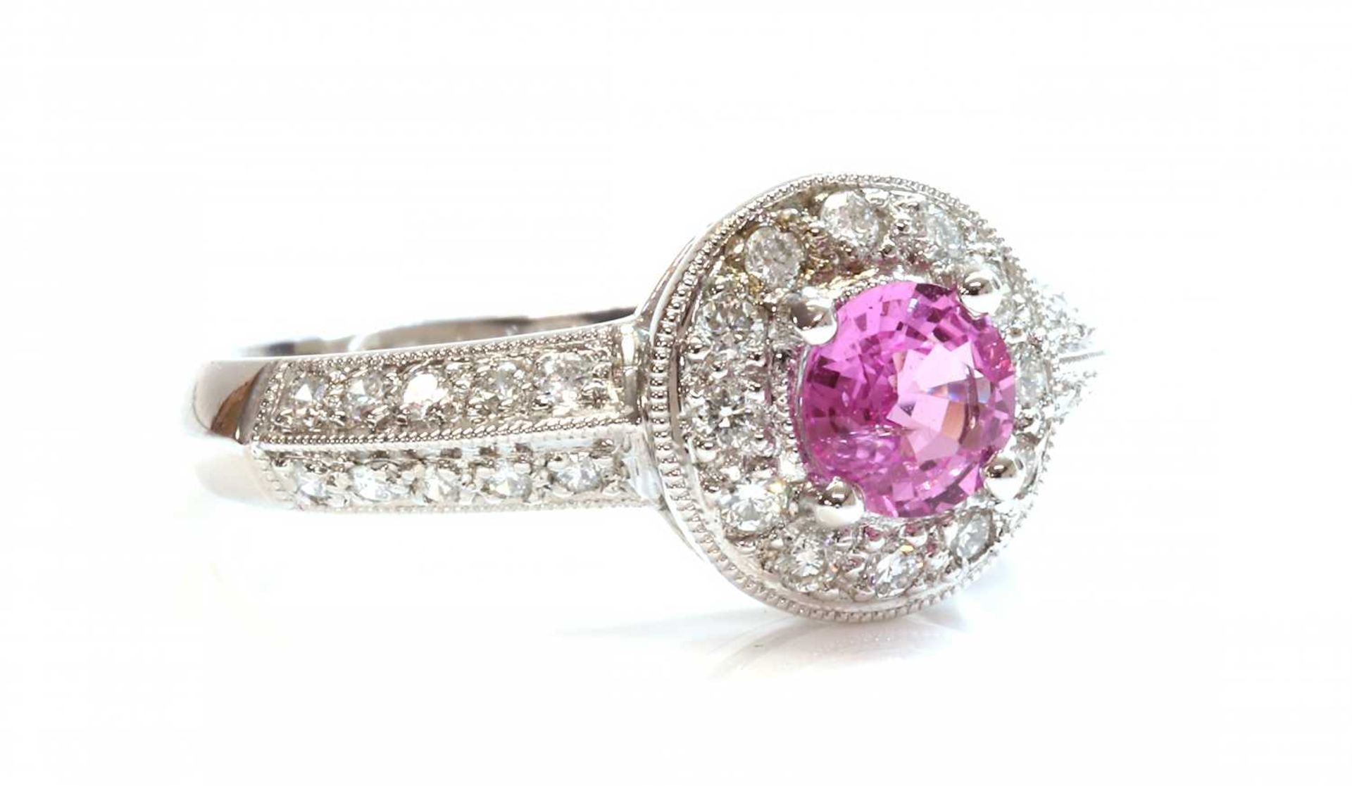 An 18ct white gold pink sapphire and diamond halo cluster ring,