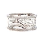 An 18ct white gold diamond set pierced band ring,