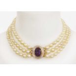 A three row graduated cultured pearl necklace with an amethyst and diamond cluster clasp,