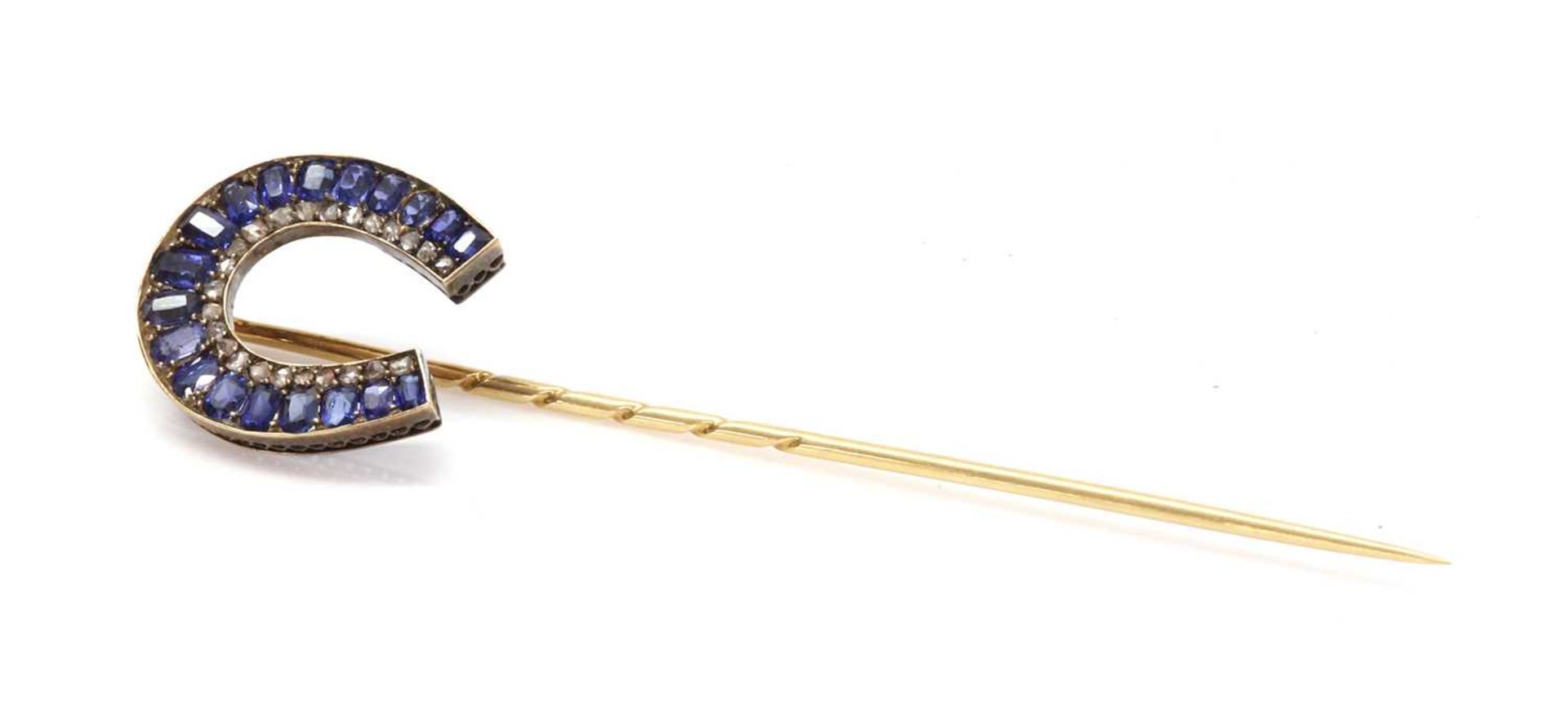 A former Austro-Hungarian sapphire and diamond horseshoe stick pin, attributed to Moritz Henolé,