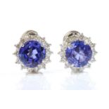 A pair of 18ct white gold tanzanite and diamond cluster earrings,