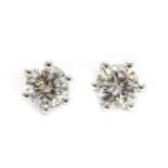 A pair of single stone diamond stud earrings,