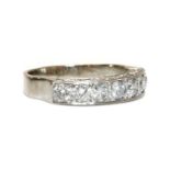 An 18ct white gold seven stone diamond half eternity ring,
