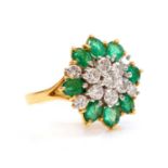 A two colour gold, diamond and emerald cluster ring,