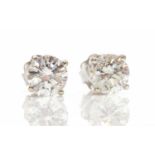 A pair of 18ct white gold single stone fracture filled diamond stud earrings,